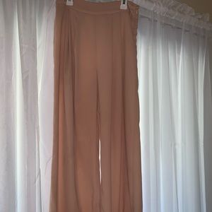 Peach colored wide leg pants.